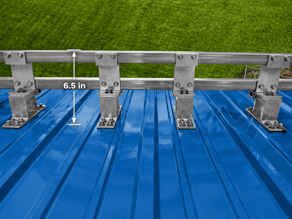 Metal roof snow guard system showing dual bars and support brackets preventing snow slide