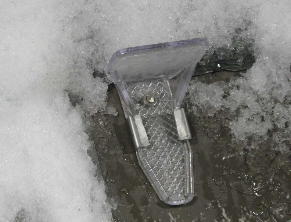 SlateGuard installed on a slate roof holding snow
