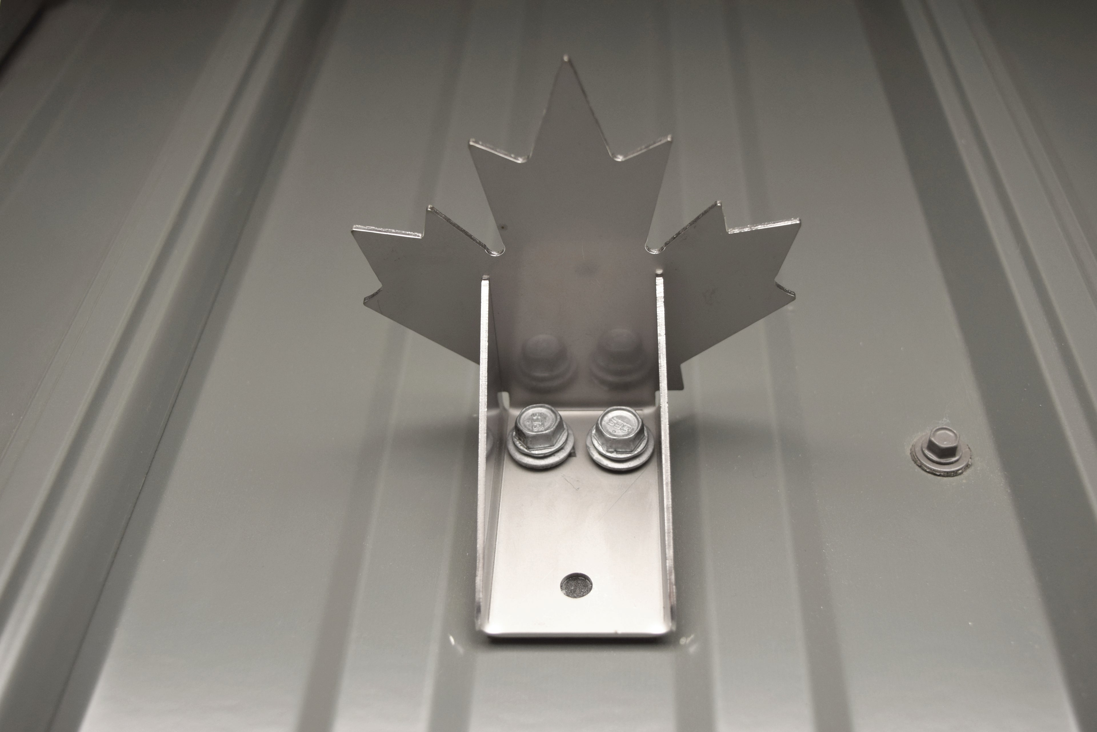 Maple leaf snow guard installed on a metal roof in Canada
