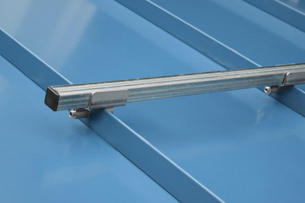 SnoBar snow rail system installed on a standing seam metal roof using non-penetrating clamps